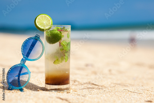 Cocktail mojito ice lemon straws in tropical beach