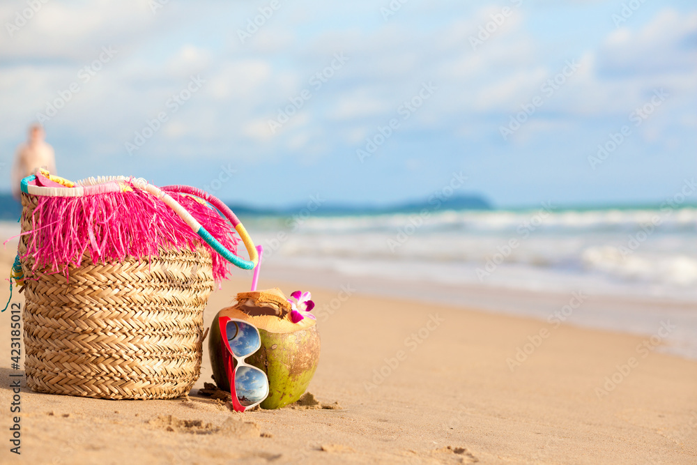 Straw hat, sun glasses and coconut on a tropical beach Straw hat, sun glasses and coconut on a tropical beach