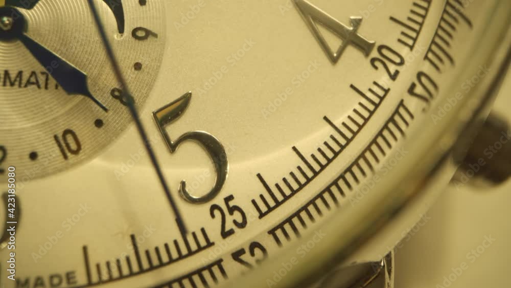 Close up of watch arrows ticking