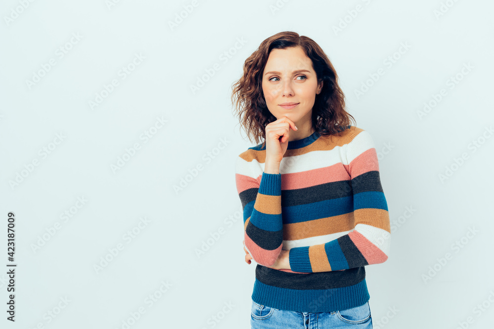 Beautiful young woman with brown curly hair having an idea Beautiful young woman with brown curly hair having an idea