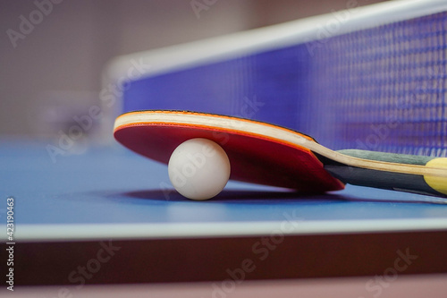 Close up of ping pong racket and a ball for table tennis photo