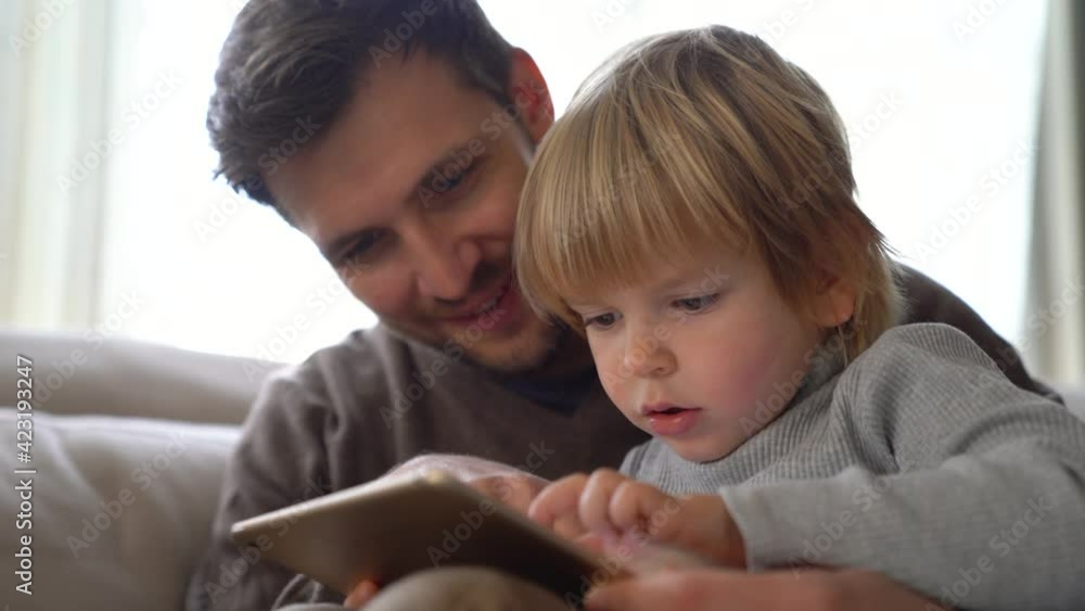 Happy loving father playing with his toddler son at home Happy loving father playing with his toddler son at home