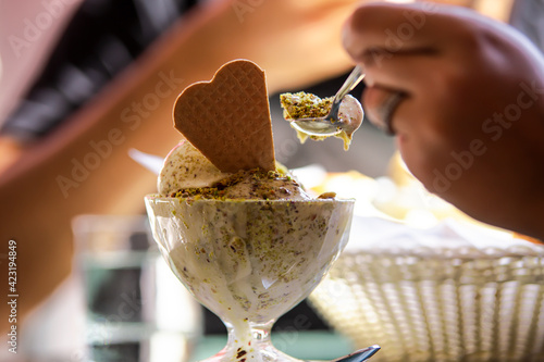 Eating pistachio gelato with spoon photo