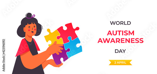World Autism Awareness Day. 2 april. Woman or girl with autistic spectrum disorder. Holding big multicolored puzzle pieces. Healthcare and medical concept. Isolated on white background.