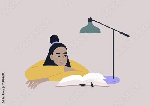 A young female Asian character leaning on arms and reading a book  educational process  a university student preparing for exams