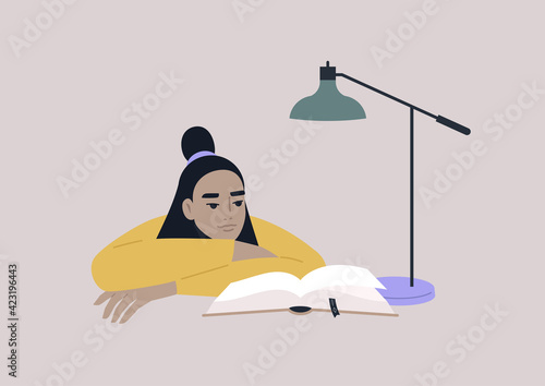 A young female Asian character leaning on arms and reading a book, educational process, a university student preparing for exams