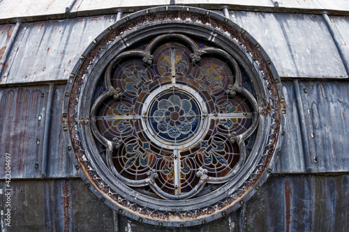 detail of a rose window and its stained glass outside on the dome of the basilica of Lourdes
