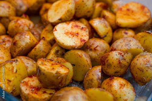New potatoes cut in half and marinated with rosemary and paprika. Beautiful food background