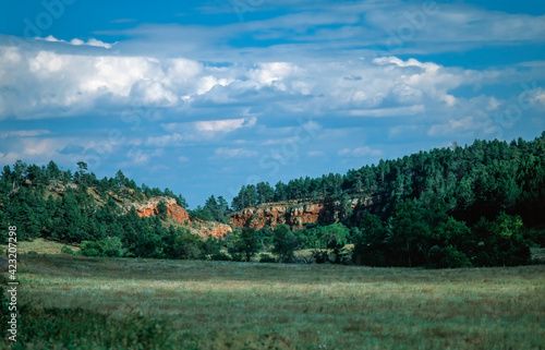 Green meadows and red sandstone cliffs in Colorado, USA photo