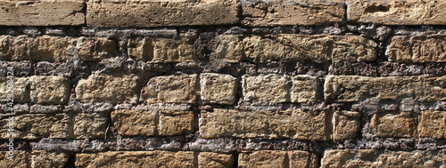 Ancient brick wall worn by time.
