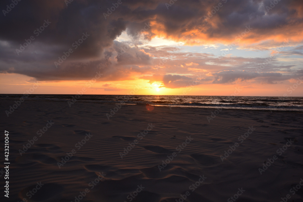 Sunset with clouds in the sky over a beach on the Baltic Sea in Poland