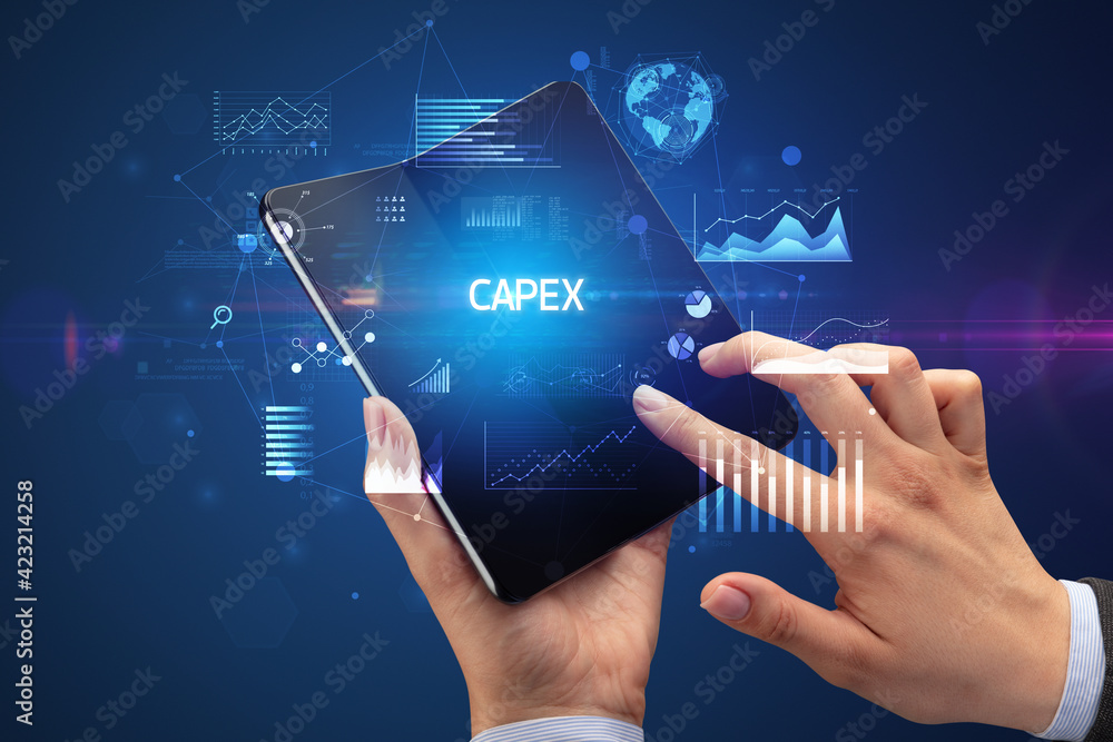 Businessman holding a foldable smartphone, business concept Businessman holding a foldable smartphone, business concept