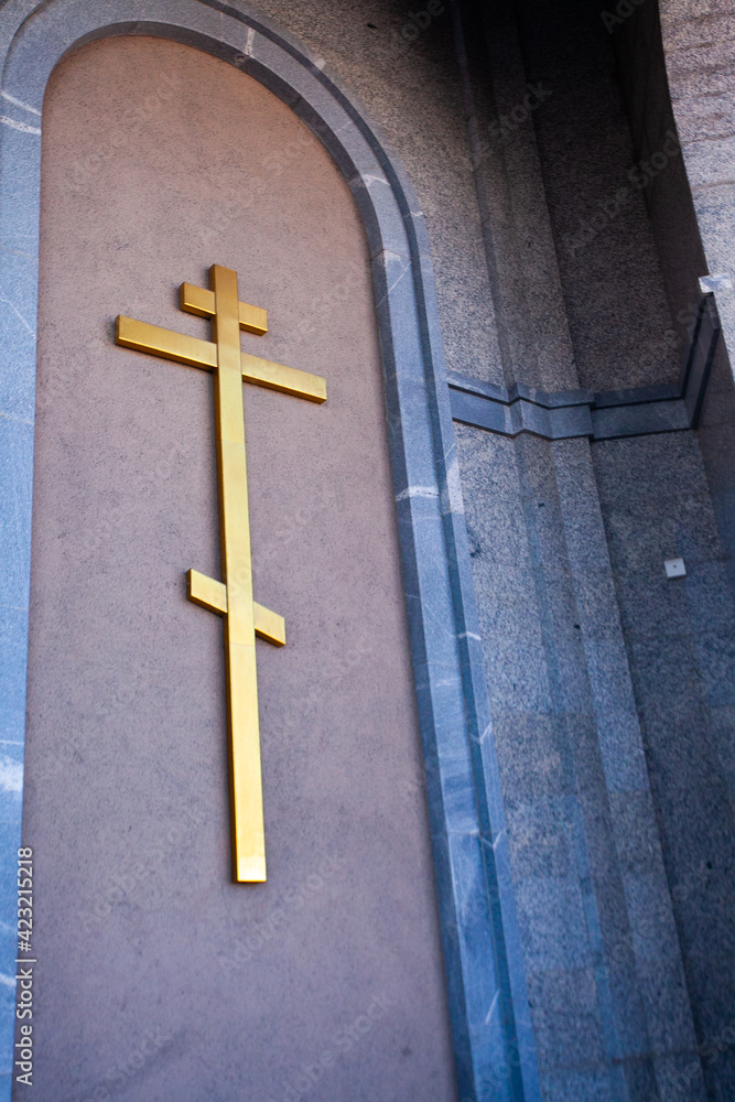 Cross on the wall of the temple, golden cross, orthodox cross