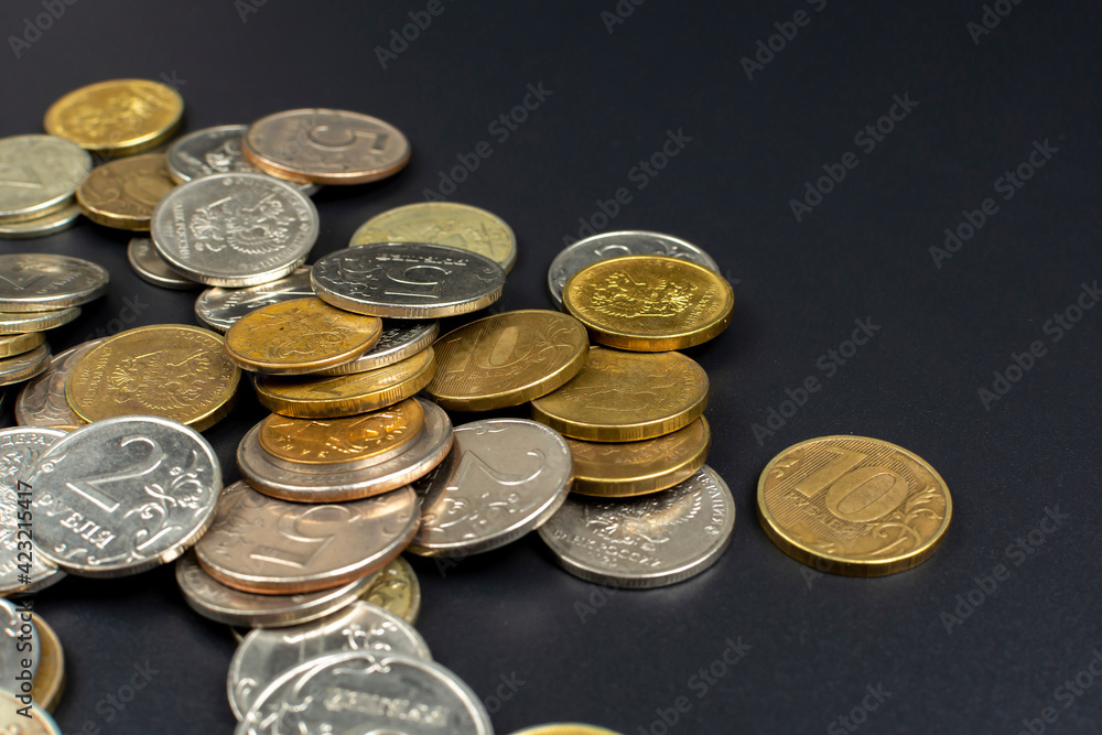 small metal coin heap on black background small metal coin heap on black background