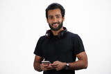A Man is using mobile with headphones and happy in white background