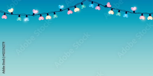 colorful heart shaped fairy lights in purple sky background