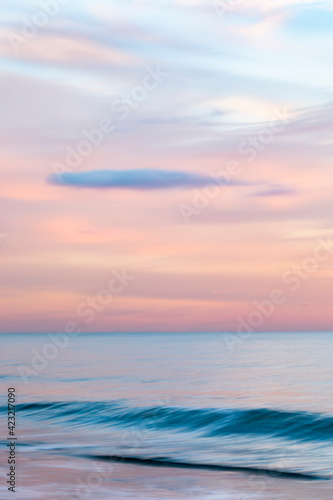 abstract landscape of sea. texture water, sky and sand in blurry motion in tropical sunset colors