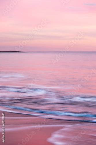 abstract landscape of sea. texture water  sky and sand in blurry motion in tropical sunset colors
