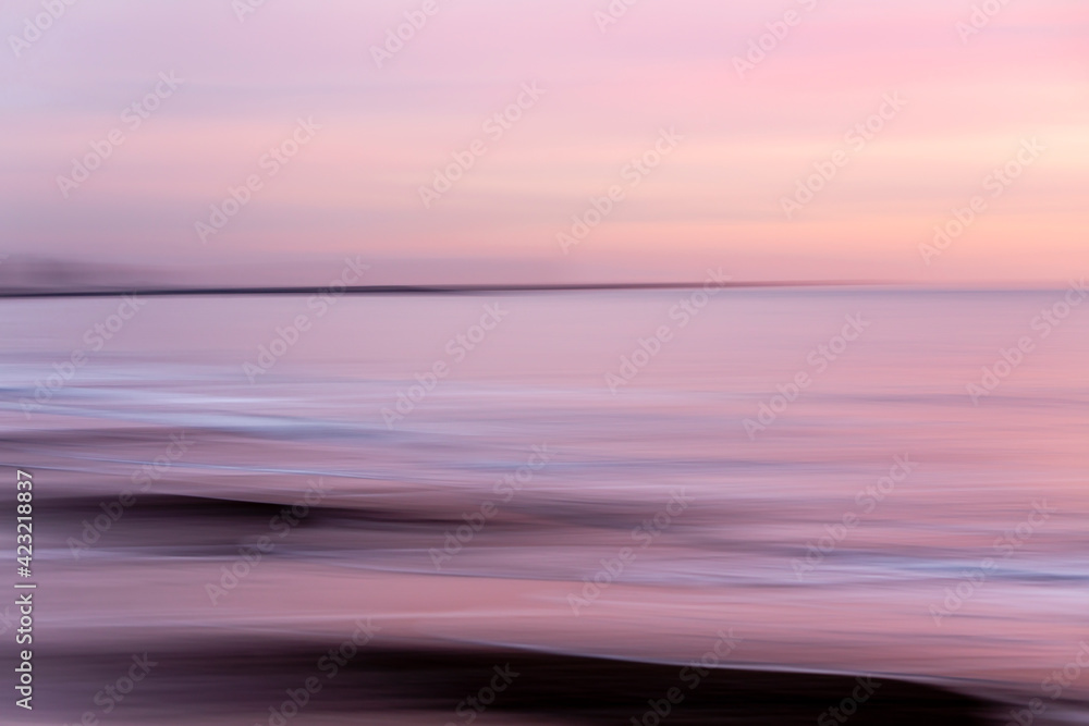 abstract landscape of sea. texture water, sky and sand in blurry motion in tropical sunset colors abstract landscape of sea. texture water, sky and sand in blurry motion in tropical sunset colors