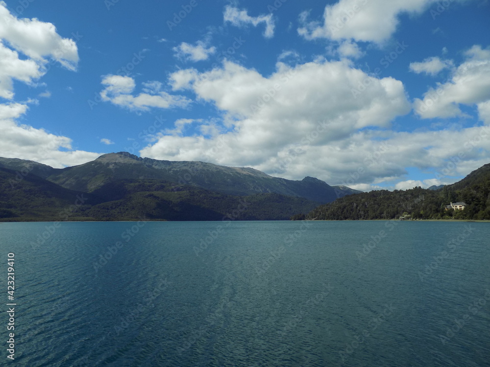 Celestial lake of Patagonia with the spectacular unique mountains and a mansion in the forest