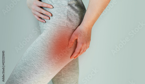A woman suffers from piriformis syndrome, pain in buttocks muscle caused by sciatic nerve irritation photo