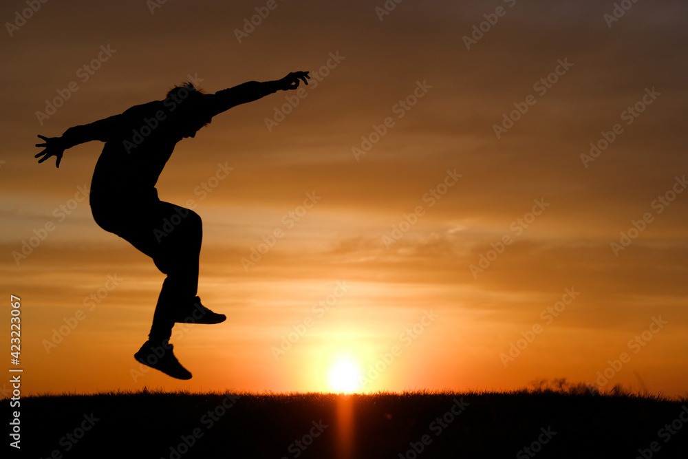 Man silhouette jump at sunset background at summer. Man silhouette jump at sunset background at summer.