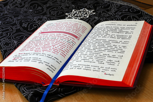 An open religious Orthodox book in the old church language lies in the church during the Orthodox liturgy. The concept of Orthodoxy.