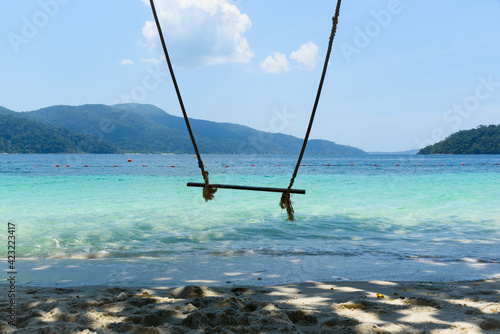 A wooden swing on the beach photo