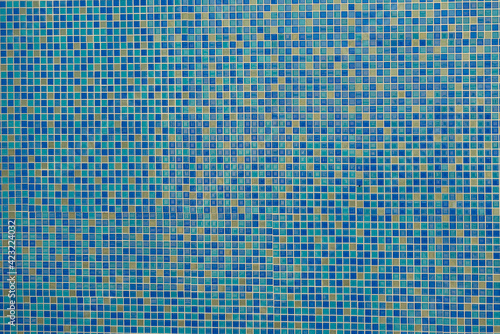 the wall is lined with colored tiles