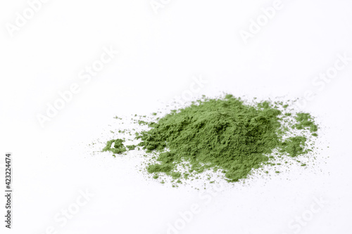 Green vegetables powder  texture on white cup at white background, copyspace