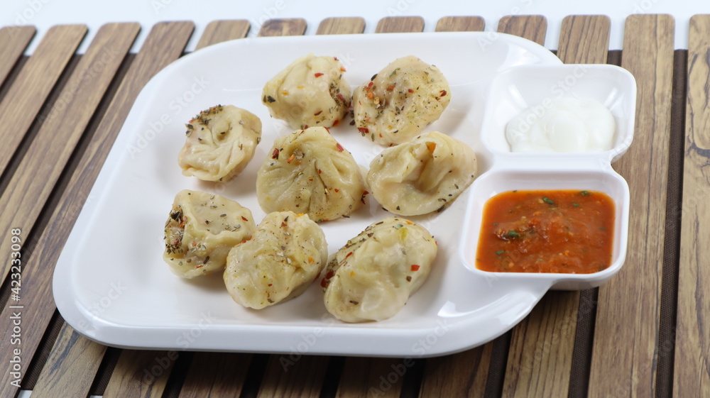Veg steam momos. Momos stuffed with vegetables and then cooked and served with sauce Veg steam momos. Momos stuffed with vegetables and then cooked and served with sauce