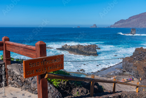 Sign saying in Spanish We only ask you not to kill yourself at La Maceta rock pool at EL Hierro island at Canary islands, Spain photo