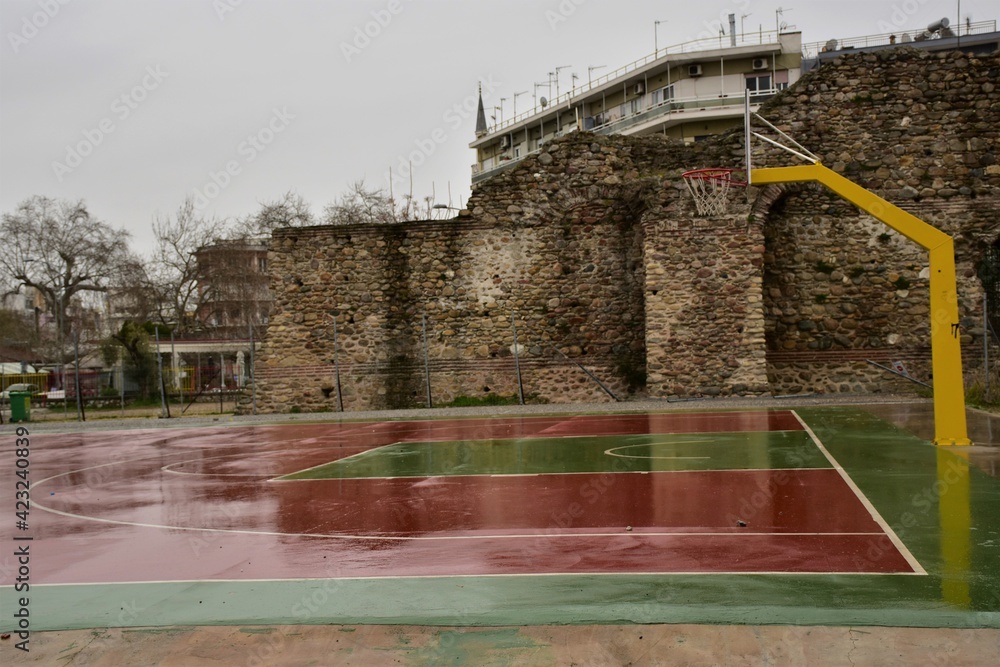 basketball court just beside ancient byzantine wall ruins