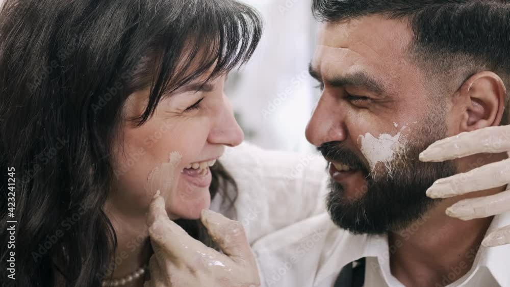 Happy married middle aged couple having a date in pottery workshop Happy married middle aged couple having a date in pottery workshop