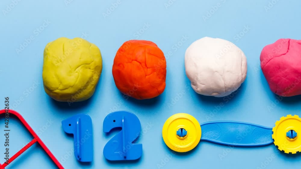 Colorful play dough. Playdough made at home on blue background. Children toys.