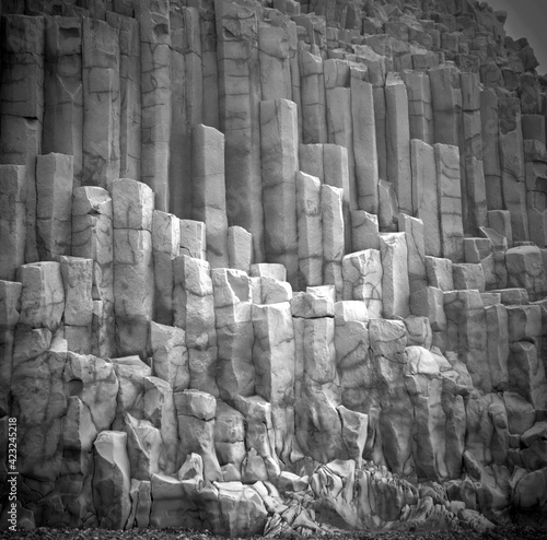 Unique natural basalt rock pillars columns  in Iceland. Geological wonder hexagonal volcanic formations in Vik beach.