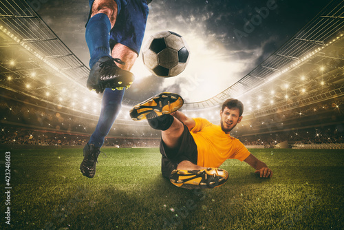 Close up of a football action scene with competing soccer players at the stadium