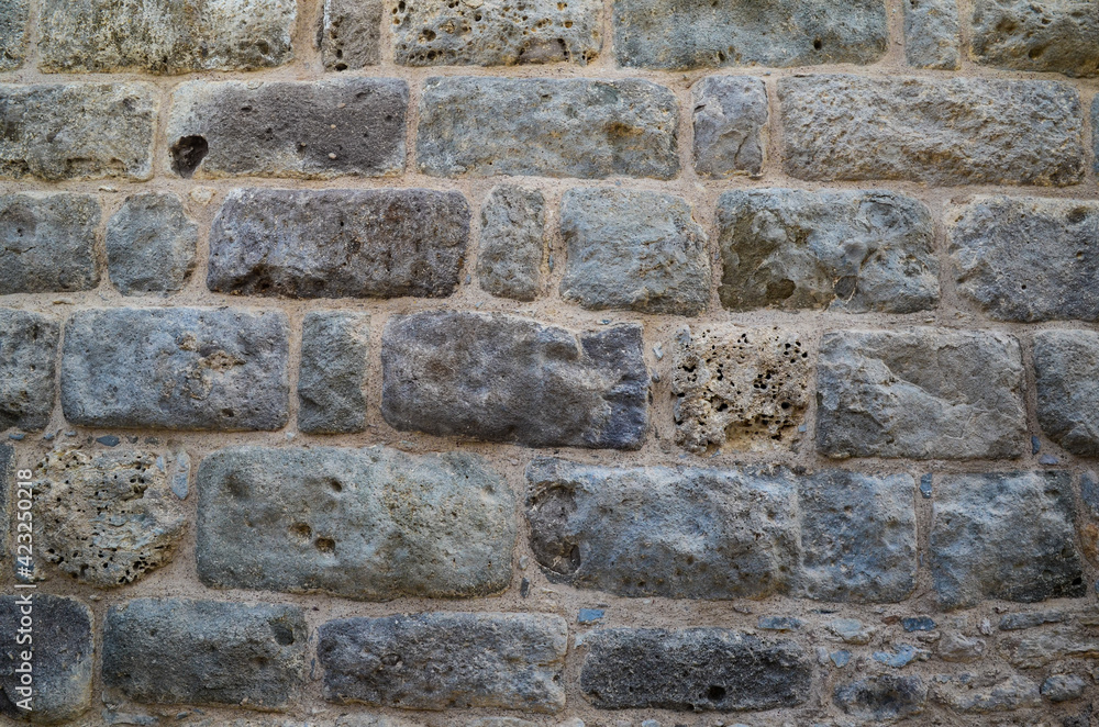 Fototapeta premium Texture of a stone wall. Old castle stone wall texture background. Stone wall as a background or texture. Part of a stone wall, for background or texture