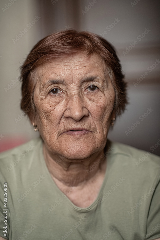 Close-up portrait of an elderly wrinkled woman. Close-up portrait of an elderly wrinkled woman.