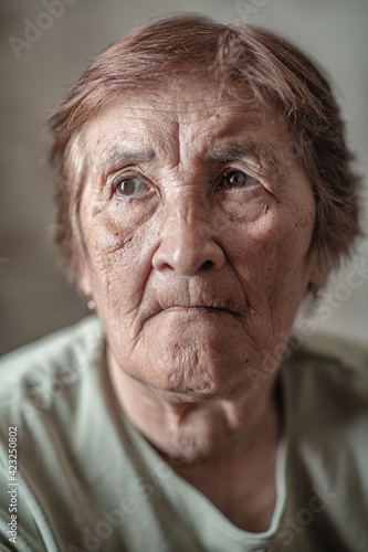 Close-up portrait of an elderly wrinkled woman. © shymar27