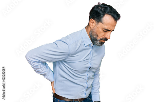 Middle aged man with beard wearing business shirt suffering of backache, touching back with hand, muscular pain © Krakenimages.com