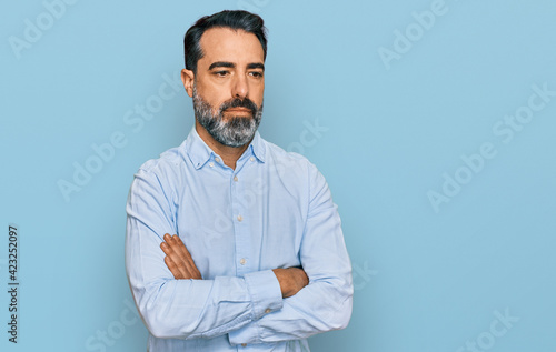 Middle aged man with beard wearing business shirt looking sleepy and tired, exhausted for fatigue and hangover, lazy eyes in the morning. © Krakenimages.com