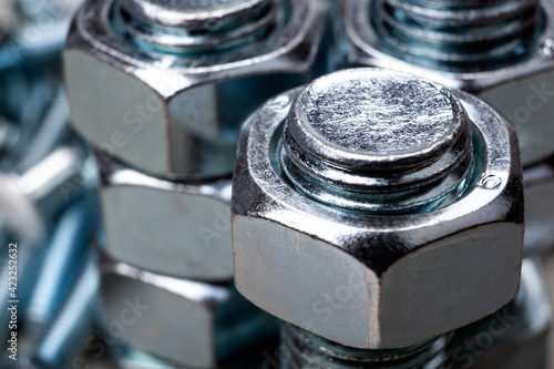 steel nuts, screwed on a bolt closeup