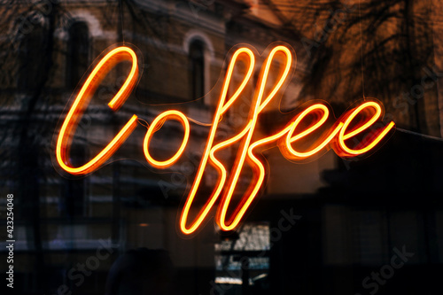 Cafe neon glowing sign with coffee lettering.