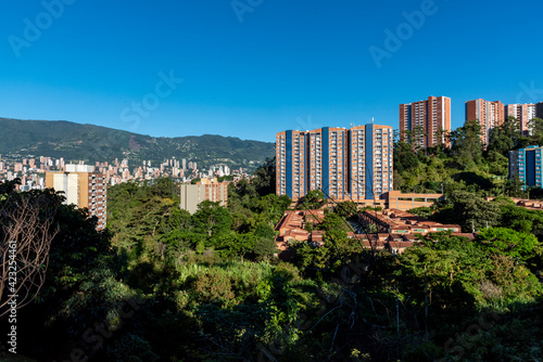 Urban landscape in medellin with buildings, trees and blue sky. photo