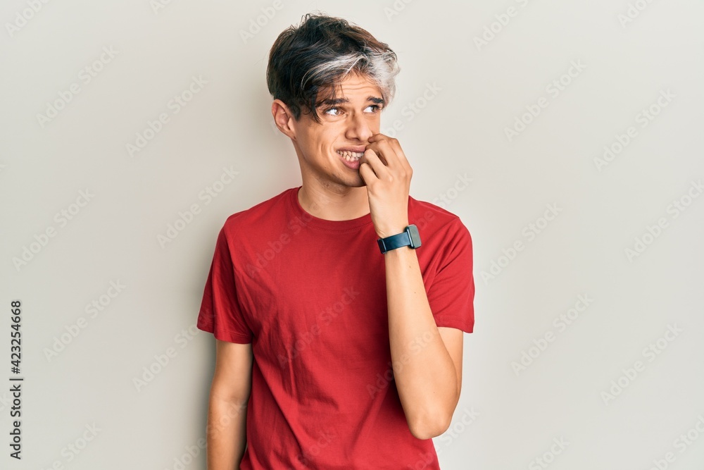 Young hispanic man wearing casual clothes looking stressed and nervous with hands on mouth biting nails. anxiety problem. Young hispanic man wearing casual clothes looking stressed and nervous with hands on mouth biting nails. anxiety problem.