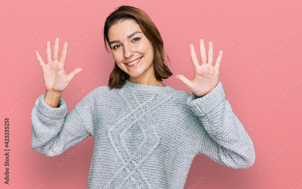 Young caucasian girl wearing casual clothes showing and pointing up with fingers number ten while smiling confident and happy. Young caucasian girl wearing casual clothes showing and pointing up with fingers number ten while smiling confident and happy.