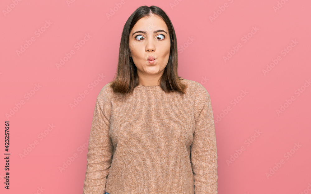 Young beautiful woman wearing casual clothes making fish face with lips, crazy and comical gesture. funny expression. Young beautiful woman wearing casual clothes making fish face with lips, crazy and comical gesture. funny expression.