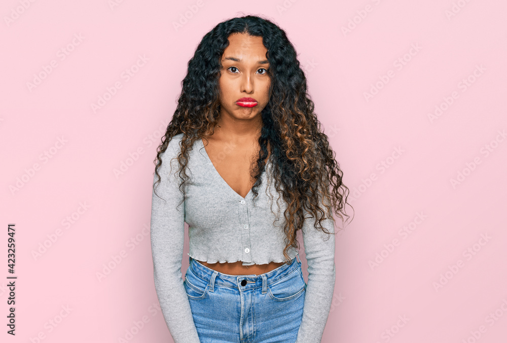 Young hispanic woman with curly hair wearing casual clothes depressed and worry for distress, crying angry and afraid. sad expression. Young hispanic woman with curly hair wearing casual clothes depressed and worry for distress, crying angry and afraid. sad expression.