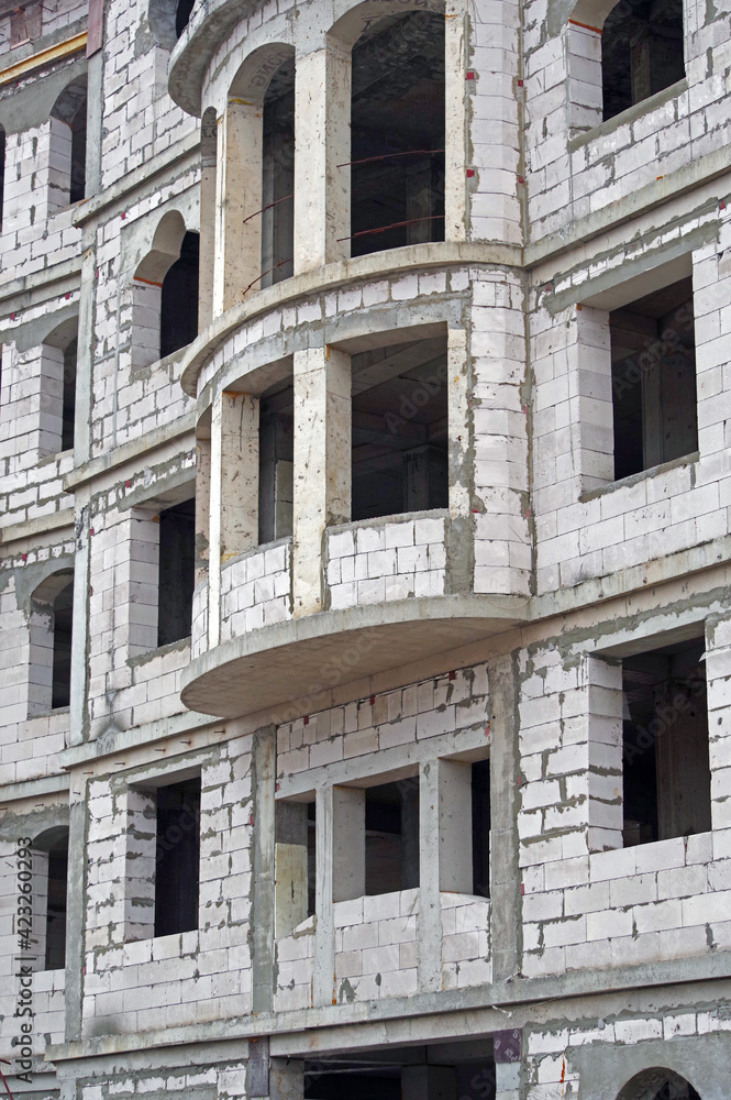 The facade of modern residential building under construction